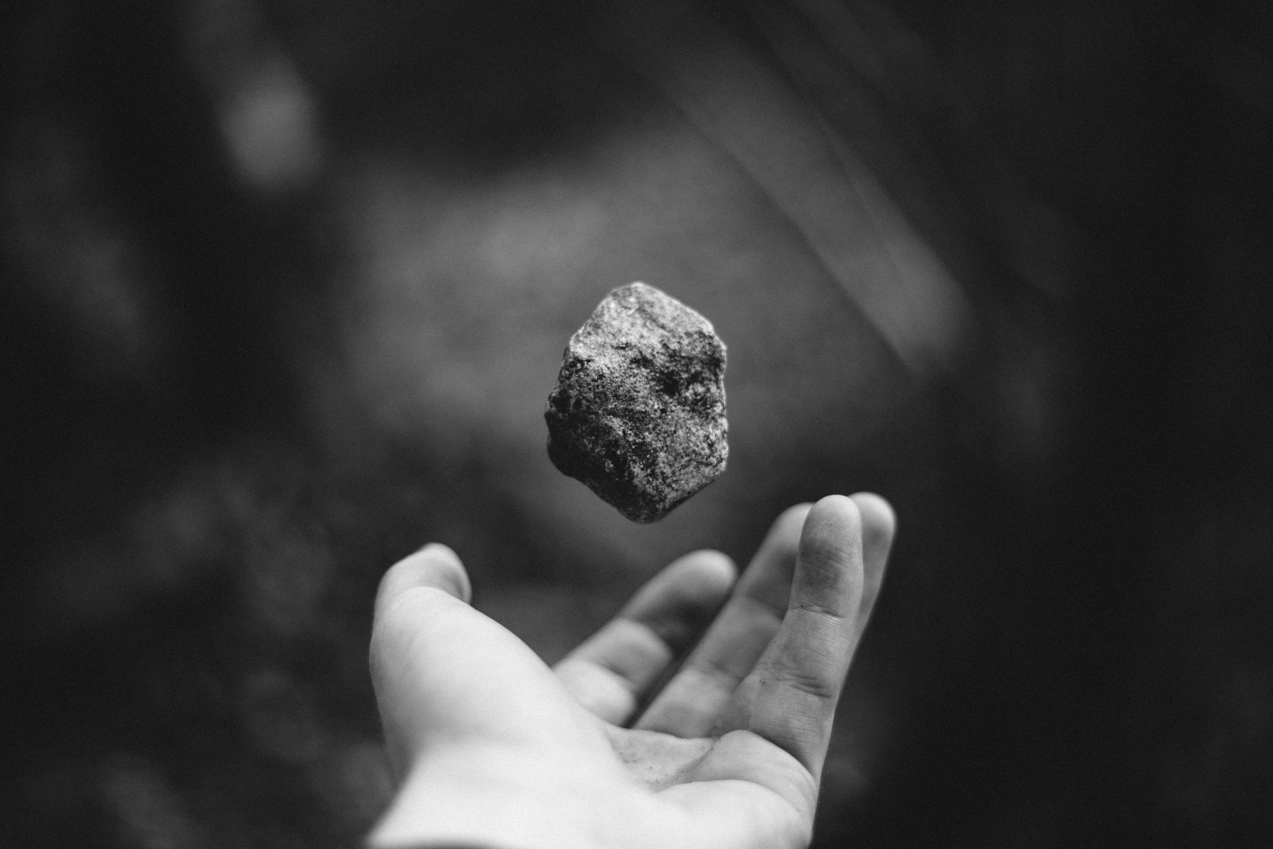 hand tossing rock